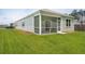 Spacious backyard with lush green grass and a screened-in porch, perfect for outdoor relaxation at 139 Sunray Ln, Summerville, SC 29486