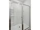 The walk-in shower features a glass door, white tile surround, and built-in shelving at 139 Sunray Ln, Summerville, SC 29486