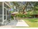 Secluded backyard with manicured landscaping, string lights, and a screened porch at 1422 Iroquois St, North Charleston, SC 29405