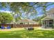 Well-maintained backyard featuring outdoor seating, a ping pong table, and lush landscaping at 1422 Iroquois St, North Charleston, SC 29405