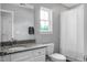 Bathroom with a vanity, granite countertop, toilet, large mirror, and shower-tub combo at 1422 Iroquois St, North Charleston, SC 29405