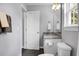 Small bathroom with a granite vanity, toilet, dark floor, mirror, and great lighting at 1422 Iroquois St, North Charleston, SC 29405