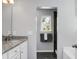 Bathroom featuring granite counters, a white vanity and black tile floors at 1422 Iroquois St, North Charleston, SC 29405