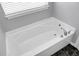 A top-down view shows the pristine white bathtub with modern fixtures at 1422 Iroquois St, North Charleston, SC 29405