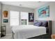 Well-lit bedroom with a comfortable bed, two large windows, and unique decor at 1422 Iroquois St, North Charleston, SC 29405