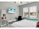 Bright bedroom with a ceiling fan, a desk, a TV, and neutral walls and carpet at 1422 Iroquois St, North Charleston, SC 29405