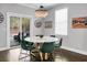 Bright dining area boasts a modern light fixture, natural light, and access to an outdoor space at 1422 Iroquois St, North Charleston, SC 29405