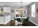 Bright dining area boasts a chandelier, dark hardwood floors, and a glass door leading to the backyard at 1422 Iroquois St, North Charleston, SC 29405