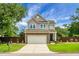 Charming two-story home featuring a brick-accented garage, beautiful lawn, and a manicured front yard at 1422 Iroquois St, North Charleston, SC 29405