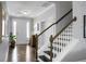Inviting foyer with hardwood floors, staircase, and a view of the bright living spaces at 1422 Iroquois St, North Charleston, SC 29405