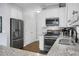 Bright kitchen with granite countertops, stainless steel appliances, and white cabinetry at 1422 Iroquois St, North Charleston, SC 29405