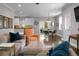 Open-concept living area featuring modern furniture, a dining space, and a kitchen with white cabinets at 1422 Iroquois St, North Charleston, SC 29405