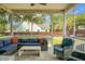 Comfortable screened porch with outdoor furniture and string lights, perfect for relaxation and entertaining at 1422 Iroquois St, North Charleston, SC 29405