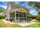 Charming exterior showcasing a screened porch with a ceiling fan and outdoor seating area at 1422 Iroquois St, North Charleston, SC 29405