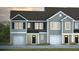 Charming townhomes with gray siding, black shutters, and attached garages create a welcoming curb appeal at 144 Haventree Ct, Summerville, SC 29486