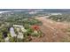 Aerial view of home nestled within lush greenery and marshland at 160 Palm Cove Way, Mount Pleasant, SC 29466