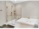 This bathroom boasts a glass enclosed shower, a deep soaking tub, and stylish neutral tile work at 160 Palm Cove Way, Mount Pleasant, SC 29466
