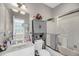 Bathroom with a tub and shower combination, a modern vanity, and a decorative storage cabinet at 160 Palm Cove Way, Mount Pleasant, SC 29466