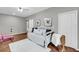 Bonus room featuring a daybed, ballet barre, hardwood floors, and hummingbird artwork adorning the walls at 160 Palm Cove Way, Mount Pleasant, SC 29466