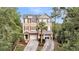 Charming townhome with shutters, a driveway, a garage, and trees in the front yard at 160 Palm Cove Way, Mount Pleasant, SC 29466