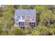 Charming two-story home with dual screened porches surrounded by lush greenery at 160 Palm Cove Way, Mount Pleasant, SC 29466