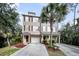 Charming townhome exterior featuring a private driveway and manicured landscaping with mature palm trees at 160 Palm Cove Way, Mount Pleasant, SC 29466