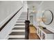 Elegant entryway with hardwood floors, staircase, and decorative lighting at 160 Palm Cove Way, Mount Pleasant, SC 29466