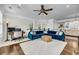 Open-concept living room with a plush blue sectional, modern decor, and plenty of natural light at 160 Palm Cove Way, Mount Pleasant, SC 29466