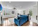 Open living room with many windows, white trim and a plush blue sectional at 160 Palm Cove Way, Mount Pleasant, SC 29466