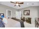 Bright main bedroom with a ceiling fan, two armchairs, and doorways to a walk-in closet and a luxurious bath at 160 Palm Cove Way, Mount Pleasant, SC 29466