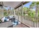 Inviting covered porch with stylish seating, perfect for outdoor relaxation surrounded by lush greenery at 160 Palm Cove Way, Mount Pleasant, SC 29466
