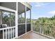 Spacious screened porch offering a serene outdoor retreat with comfortable seating and scenic views at 160 Palm Cove Way, Mount Pleasant, SC 29466