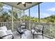Relaxing screened porch with comfortable seating and views of lush greenery and beautiful landscaping at 160 Palm Cove Way, Mount Pleasant, SC 29466