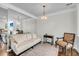 Sitting room features a mirrored wall, plush sofa, accent chair and hardwood floors at 160 Palm Cove Way, Mount Pleasant, SC 29466