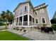 Charming backyard with screened porch, paved patio, and lush landscaping at 1615 Paradise Lake Dr, Mount Pleasant, SC 29464