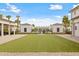 The community backyard has artificial grass, framed by charming buildings and manicured hedges for outdoor recreation at 1714 Fort Palmetto Cir, Mount Pleasant, SC 29466
