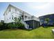 Spacious backyard with a playset, lush green lawn, and a staircase leading to a covered porch at 1714 Fort Palmetto Cir, Mount Pleasant, SC 29466