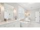 Bright, all-white bathroom features double sinks, a soaking tub, and modern fixtures at 1714 Fort Palmetto Cir, Mount Pleasant, SC 29466