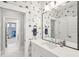 Stylish bathroom with a bright vanity, framed mirror, and decorative wallpaper at 1714 Fort Palmetto Cir, Mount Pleasant, SC 29466