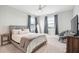 Bright bedroom features neutral walls, carpet, ceiling fan, and stylish decor, creating a cozy and inviting space at 1714 Fort Palmetto Cir, Mount Pleasant, SC 29466