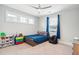 Cozy bedroom with large windows, a modern ceiling fan, and comfortable furnishings at 1714 Fort Palmetto Cir, Mount Pleasant, SC 29466