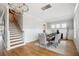 Elegant dining room with a table set for eight and stylish light fixture, adjacent to the stairs at 1714 Fort Palmetto Cir, Mount Pleasant, SC 29466