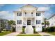 Stunning two-story white home with black shutters, double garages, palm trees and beautiful lawn at 1714 Fort Palmetto Cir, Mount Pleasant, SC 29466