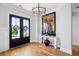 Welcoming foyer with hardwood floors, art and double doors with wreaths on them at 1714 Fort Palmetto Cir, Mount Pleasant, SC 29466