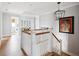 Upstairs hallway with wood floors, railing, and view to the laundry room at 1714 Fort Palmetto Cir, Mount Pleasant, SC 29466