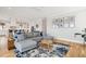 Bright, open-concept living room with hardwood floors, sectional seating, and view of the kitchen at 1714 Fort Palmetto Cir, Mount Pleasant, SC 29466