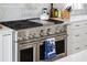 Close up on a stainless steel gas range with double ovens and marble backsplash at 1714 Fort Palmetto Cir, Mount Pleasant, SC 29466