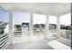 Covered porch with white columns and railings offering neighborhood views and a glimpse of the lake at 1714 Fort Palmetto Cir, Mount Pleasant, SC 29466
