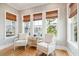 Cozy sunroom featuring large windows, hardwood floors, and comfortable seating at 1714 Fort Palmetto Cir, Mount Pleasant, SC 29466