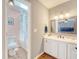 Bright bathroom featuring a vanity, mirror, and a doorway to an adjacent pink tiled shower at 1743 Orange Grove Shores Dr, Charleston, SC 29407